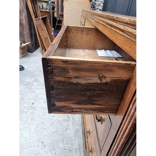 1051 - A George III oak, walnut crossbanded and line inlaid dresser base, 187cm wide.