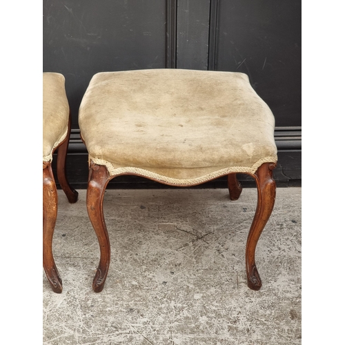 1056 - A pair of late 19th century walnut and upholstered stools.