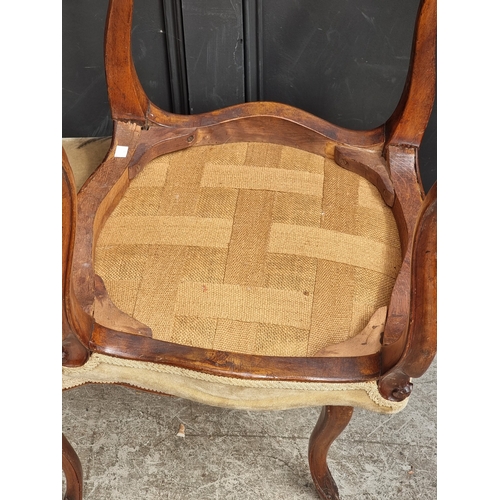1056 - A pair of late 19th century walnut and upholstered stools.