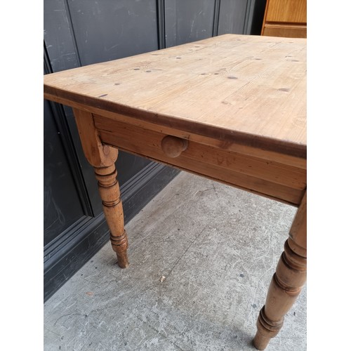 1013 - An antique pine kitchen table, with lateral frieze drawer, 120cm long.