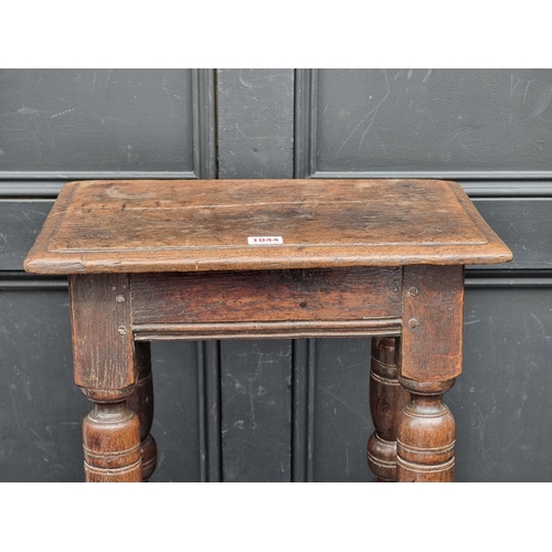 1044 - A late 17th century oak joint stool, 44.5cm wide.