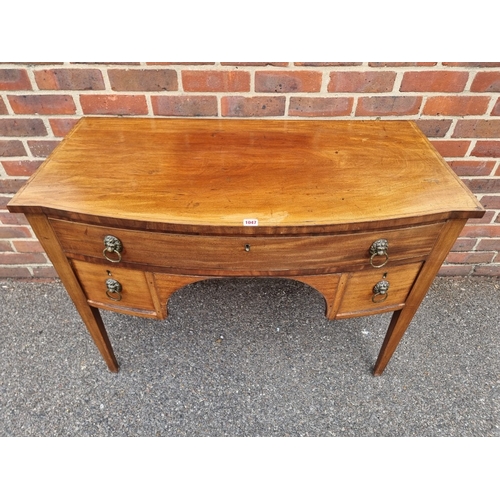 1047 - A George III mahogany and chequer strung bowfront kneehole side table, 107.5cm wide.... 