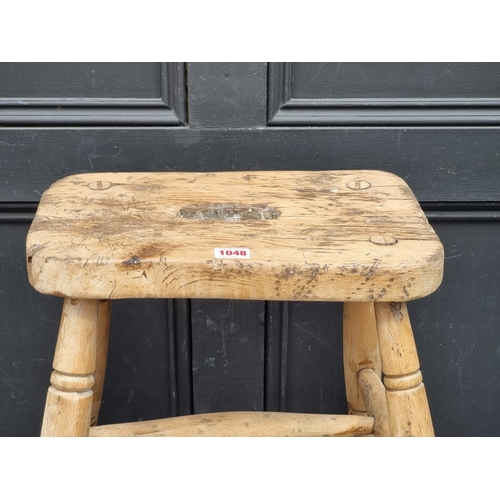 1048 - A Victorian pine and elm stool, 47cm high.