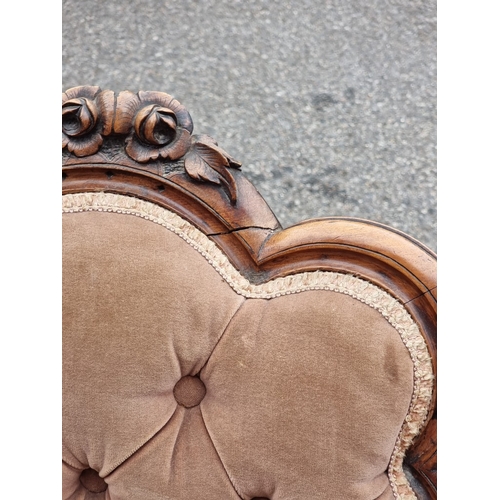 1054 - A Victorian carved walnut and button upholstered occasional chair.