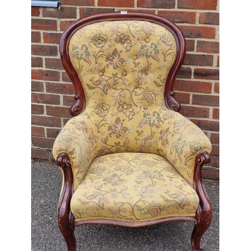 1058 - A Victorian mahogany and button upholstered occasional armchair.