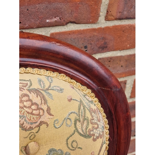 1058 - A Victorian mahogany and button upholstered occasional armchair.