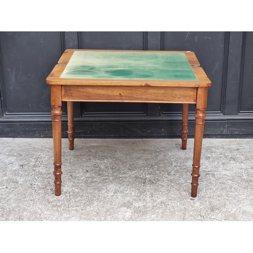 A Victorian walnut rectangular card table, with telescopic action.