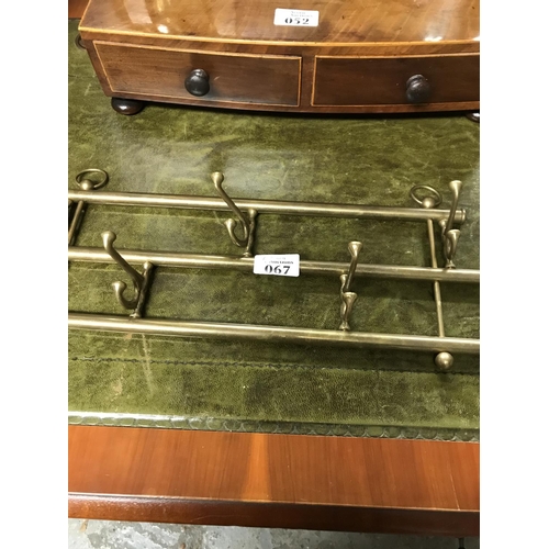 67 - Lovely set of brass coat hooks on a folding rail