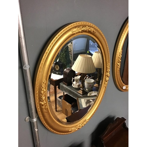 405 - Pair of gilt framed oval mirrors - 24 inches x 20 inches - COLLECTION ONLY