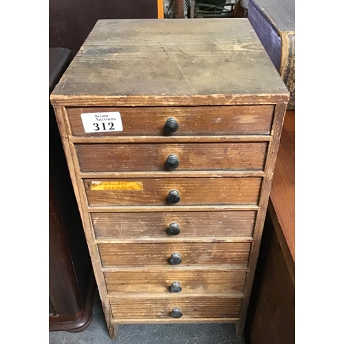 312 - 7 Drawer wooden watchmakers cabinet with various watchmakers tools and watch parts inside the drawer... 