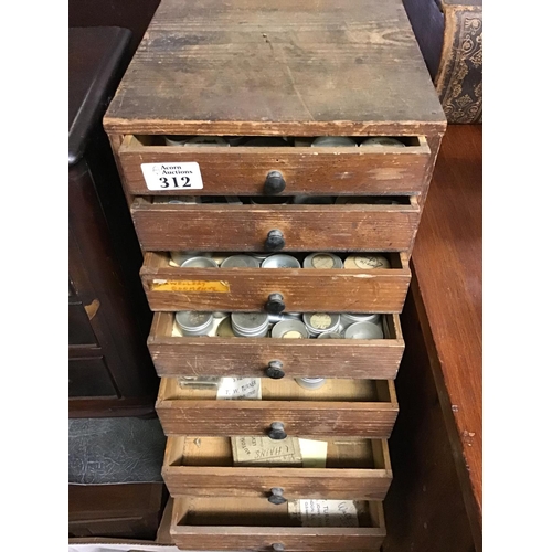 312 - 7 Drawer wooden watchmakers cabinet with various watchmakers tools and watch parts inside the drawer... 