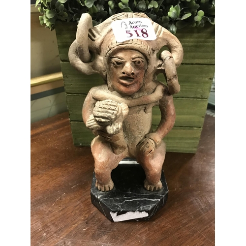 518 - Unusual pottery figure on marble base