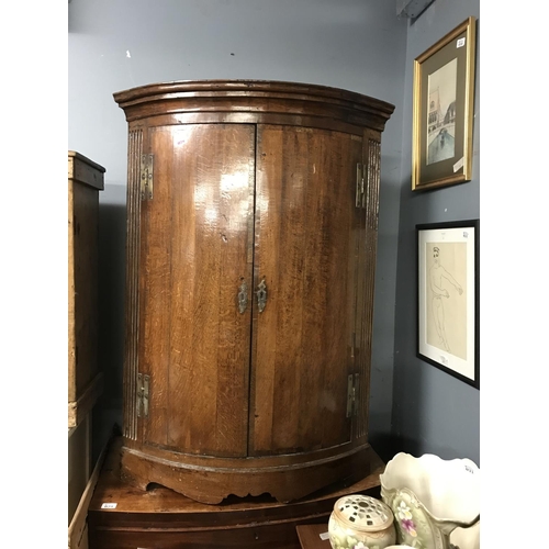 28 - LARGE ORNATE BOW FRONTED CORNER CABINET 46