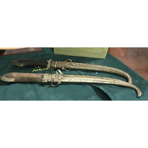 449 - 2 x Decorative Arabic daggers in metal sheaths...