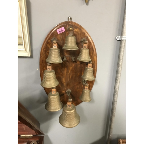 26 - 8 X BRASS BELLS OF VARIOUS SIZES MOUNTED ON A BOARD