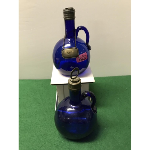 43 - 2 X COBALT BLUE VINTAGE GLASS DECANTERS - 1 X WITH A GIN LABEL - 1 X STOPPER MISSING