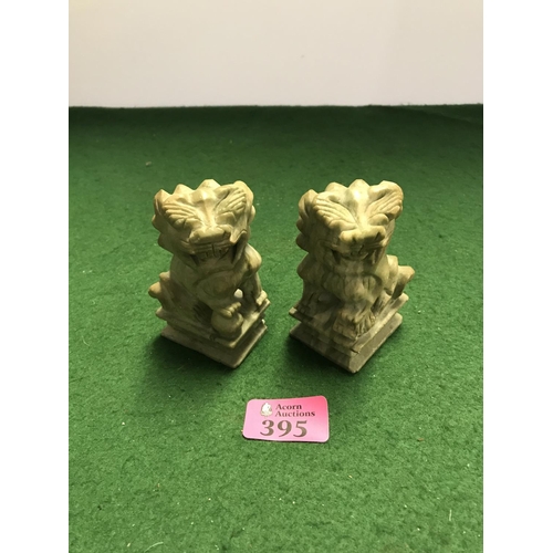 395 - PAIR OF NATURAL STONE CARVED ORIENTAL DOGS OF FOE - SMALL CHIP TO BASE - 9CMS H