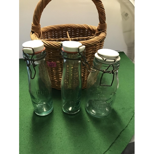 602 - WHICKER BASKET WITH 3 X FRENCH GLASS BOTTLES