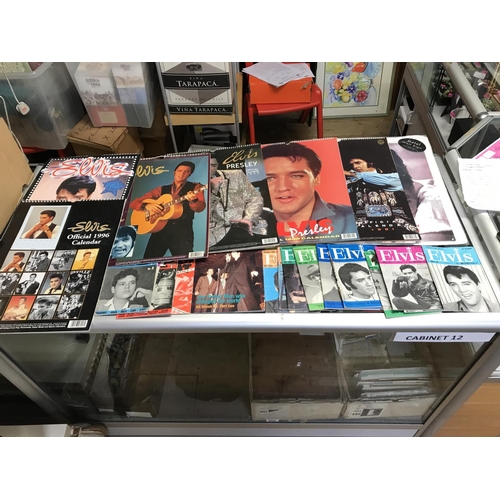 785B - LARGE BOX OF ELVIS CALENDARS & ELVIS MONTHLY PAPER BOOKS  & TIN SIGN