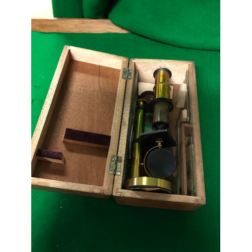 107 - VINTAGE CASED SMALL MICROSCOPE WITH SOME PLATES