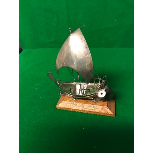 202 - SMALL METAL YATCH ON WOODEN STAND - OVERALL LENGTH 12CMS X 14CMS H