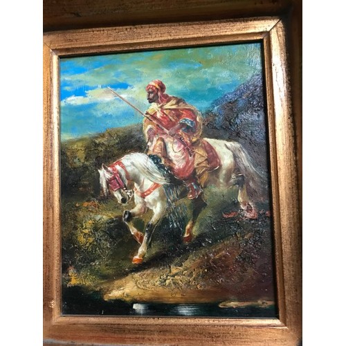 349 - VERY HEAVILY GILT FRAMED OIL ON BOARD OF AN ARABIC SOLDIER ON HORSEBACK - 46CMS X 52CMS