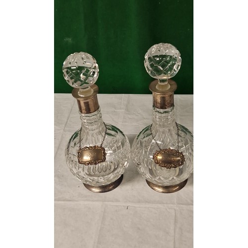 712 - PAIR OF GOOD QUALITY VICTORIAN CUT GLASS DECANTERSWITH PLATED COLLARS & SILVER HALLMARKED PORT & BRA... 