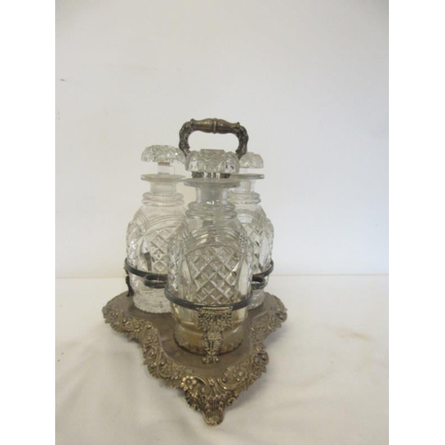 122 - A good antique glass decanter set comprising of three cut glass decanters and stoppers on Sheffield ... 