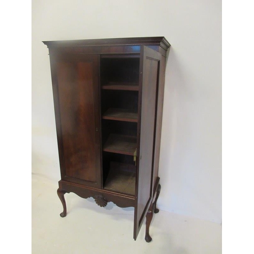 130 - Fine antique Irish mahogany two door cabinet with shelved interior and raised on pad foot base with ... 