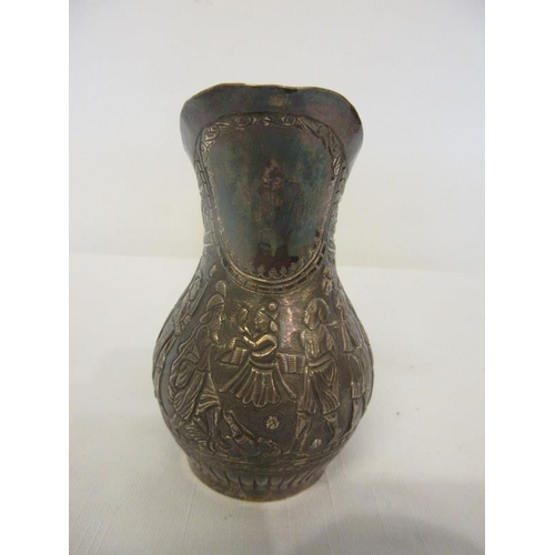 154 - Silver jug extensively decorated with figures.