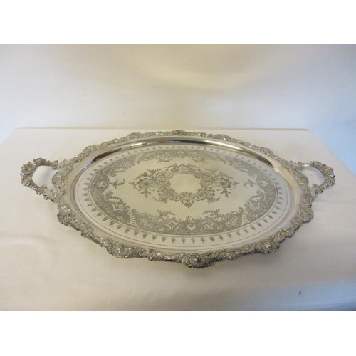 172 - A good old silver plated two handled tray of oval shape and decorative border. W. 27