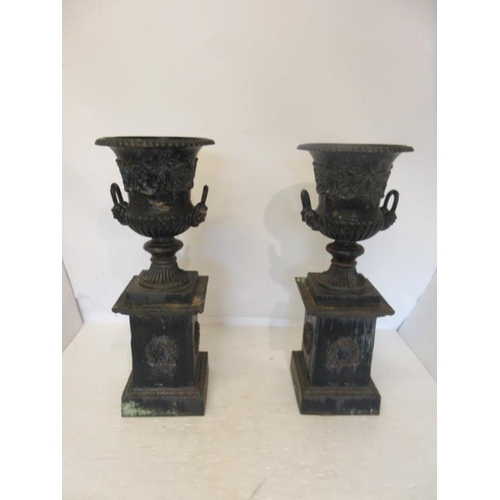 211 - Pair of antique cast iron garden urns and bases. H. 44