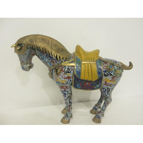 220 - A Chinese Cloisonne enamel figure of a standing war horse. In the style of a pottery horse of the Ta... 