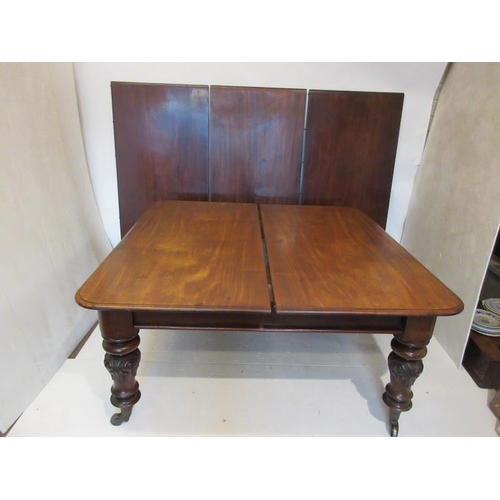 240 - A good early 19th century dining table having three large leaves and raised on well carved turned le... 