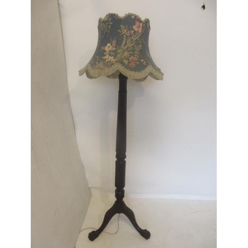 63 - Antique carved mahogany standard lamp on tripod base with hairy claw feet.