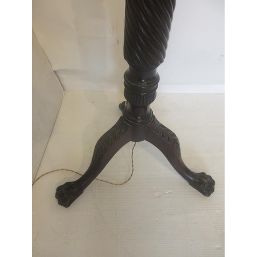 63 - Antique carved mahogany standard lamp on tripod base with hairy claw feet.