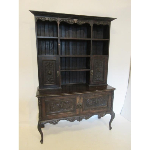 65 - Antique carved oak dresser, the upper section with cupboards and open shelves, the base with two cup... 