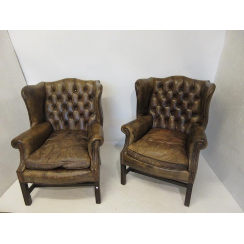 69 - A good pair of antique mahogany framed and leather upholstered wing back drawing room or library cha... 