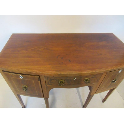 94 - A Georgian mahogany bow shaped sideboard, inlaid with satinwood, gilt brass handles and raised on ta... 