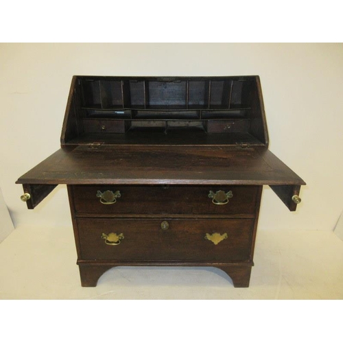 110 - Early Georgian oak writing bureau raised on bracket feet. Width 36