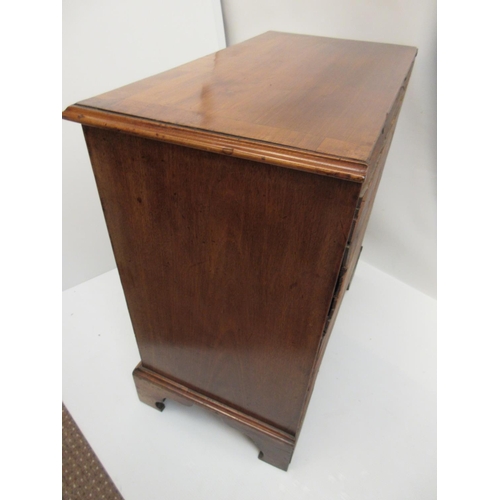 234 - A neat size Georgian mahogany chest having four graduated drawers and raised on bracket feet. W. 34