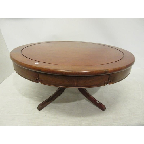 235 - A good quality mahogany circular coffee table fitted with four drawers and raised on pod support. Di... 