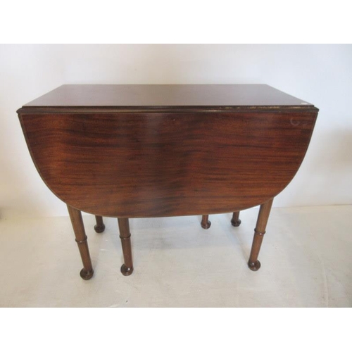 256 - Mahogany drop leaf table raised on six turned legs.  W. 3ft  Fully opened 48