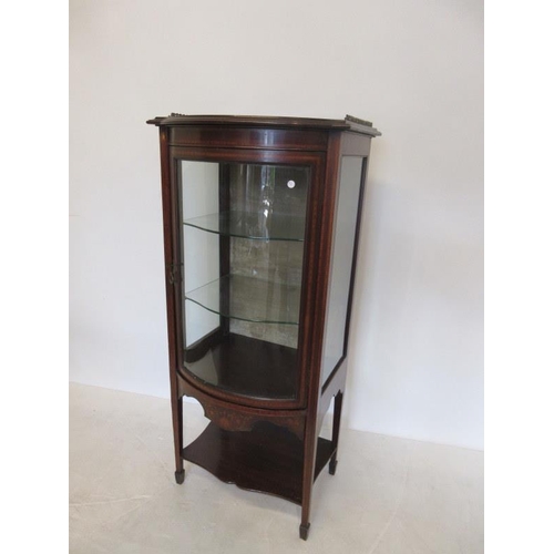 60 - An Edwardian inlaid mahogany drawing room cabinet having curved glass door, brass gallery and raised... 