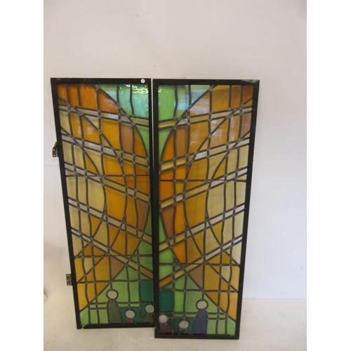 77 - A pair of tall metal framed leaded and stain glass panels,(probably part of a window). 56 1/2