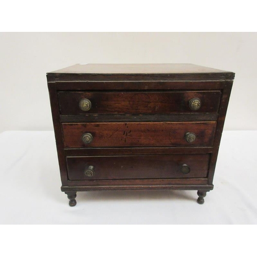 99 - A 19th century miniature mahogany two sided cabinet fitted with drawers and raised on turned legs. (... 