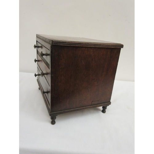 99 - A 19th century miniature mahogany two sided cabinet fitted with drawers and raised on turned legs. (... 