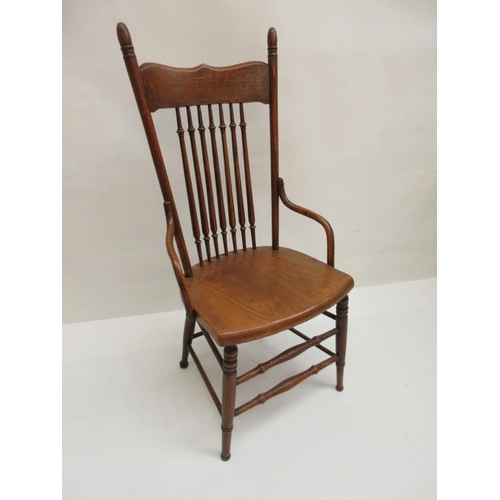 64 - An Edwardian oak spindle back easy chair.