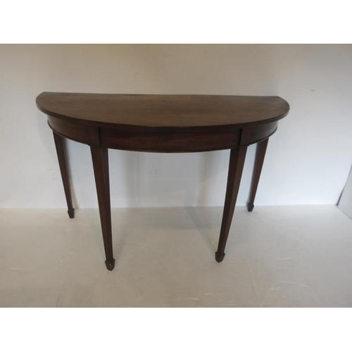 68 - Georgian mahogany demi lune side table raised on tapered legs ending with spade feet. Width 126cm De... 