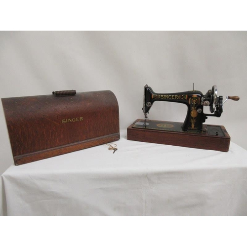 10 - Old Singer sewing machine complete with cover and key.